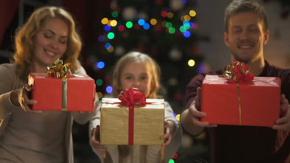 Happy Family Receiving X-Mas Presents, Tree and Lights Glowing, Dreams Come True