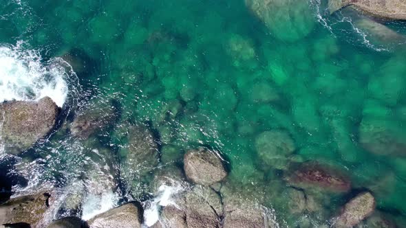 Aerial view Drone camera top down of seashore rocks in ocean Beautiful sea surface Amazing sea waves