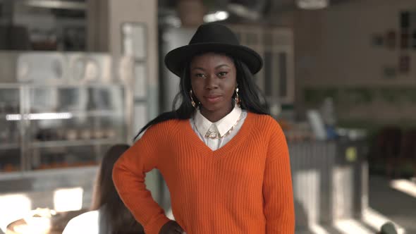 Stylish African Woman Posing at Modern Cafe