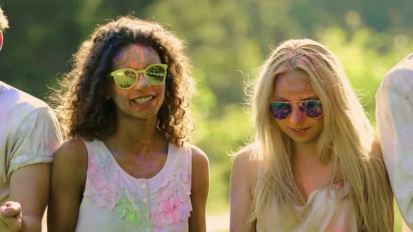 Beautiful Young People Covered in Powder Paint Dancing and Smiling at Concert