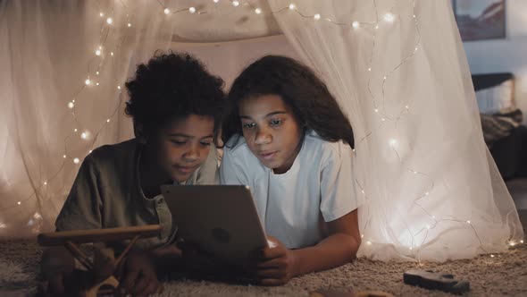 Kids Using Tablet in Handmade Tent