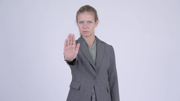 Young Serious Blonde Businesswoman Showing Stop Gesture