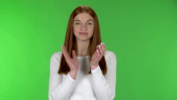 Portrait of Pretty Young Woman Is Clapping Her Hands Indifferent.