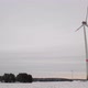 Low angle shot of rotating wind turbines on a snowy field in Germany. Wide shot of a wind farm. - VideoHive Item for Sale