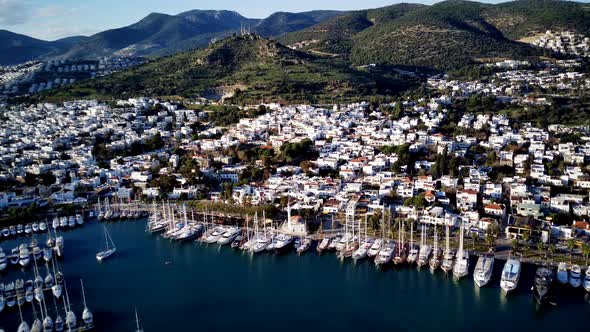 View from drone on full of yachts Bodrum harbour and ancient Kalesi castle in Mugla in Turkey