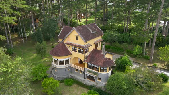 Aerial drone flying around a villa with French colonial style built in Dallat in sunshine reveal nic