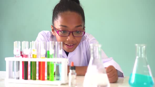 Young African American Kid Using Microscope in Lab