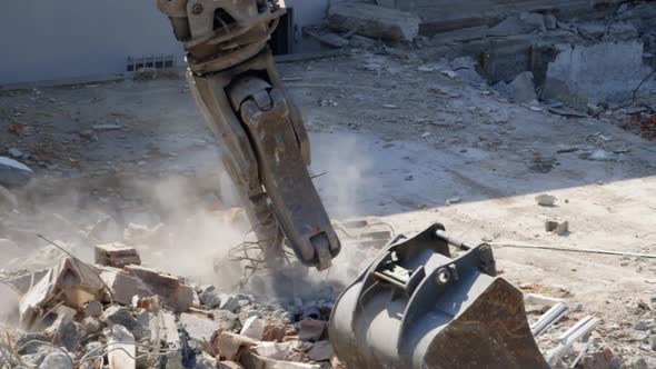 close up shot of an excavatoring debris at a demolition lot by the river.