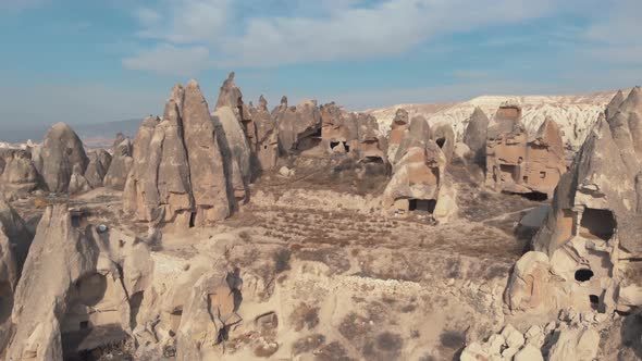 4k aerial drone footage of Cappadocia, tall, cone-shaped rock formations often carved into homes
