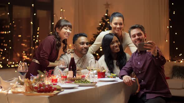 Friends Having Christmas Dinner and Taking Selfie