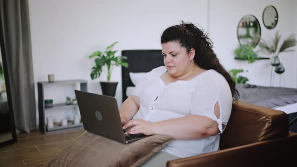 Young Overweight Lady Employee Works From Home Armchair