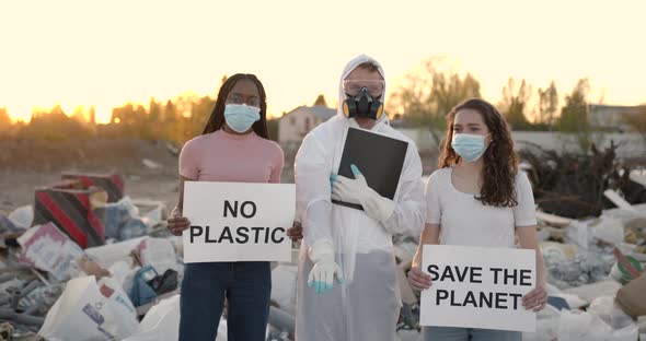 Eco Activists at Garbage Dump with Signs