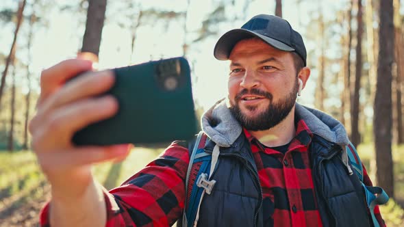 Young Attractive Man During the Hike Hold Mobile Phone Share Message to Friend Distantly Use Social