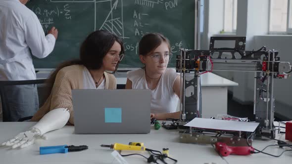 Focused Girls Look on the Laptop's Screen