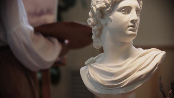 Young Woman Artist Drawing a Painting  Marble Bust on the Foreground