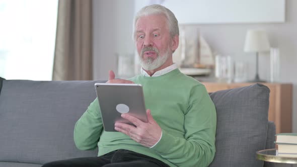 Old Man Doing Video Chat on Tablet at Home