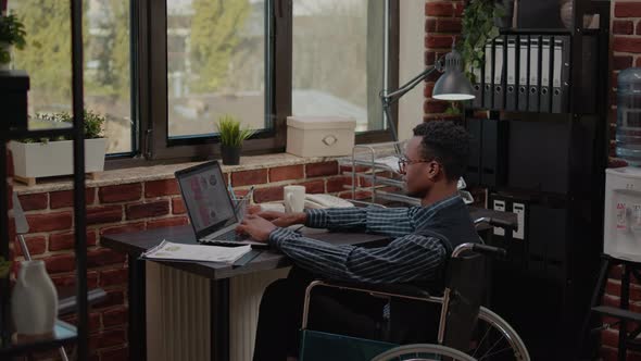 African American Worker with Chronic Disability Using Laptop