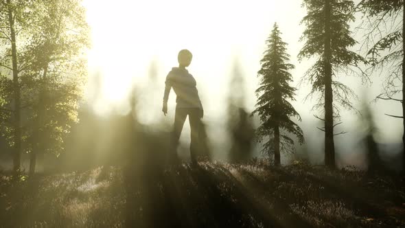 Young Woman Standing Alone Outdoor with Wild Forest Mountains