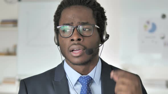 African Businessman Talking with Customer in Call Center