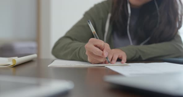 Woman do revision with cellphone at home