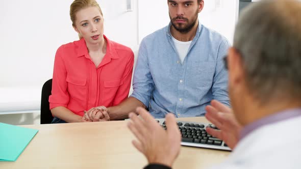 Couple Visiting Doctor at Family Planning Clinic 