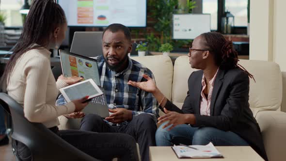 Group of African American Colleagues Collaborating on Project