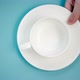 Woman Puts Cup with Saucer on Table - VideoHive Item for Sale