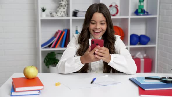 Lazy Female Student in School Uniform Using Cell Phone During the Lesson Smartphone