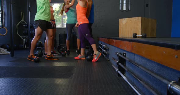 Fitness people high fiving each other in gym