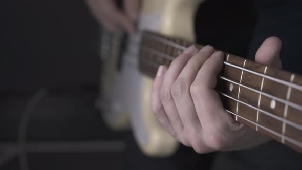 Musician Plays Solo on White Bass Guitar with Pitch Shift