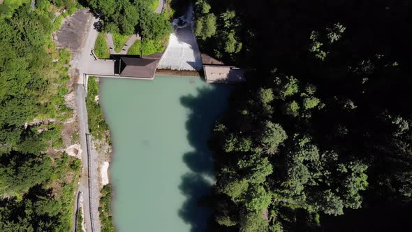 Top View Of The Green Woods Surrounded The Waterscape Of Klammsee Lake In Kaprun, Austria. aerial