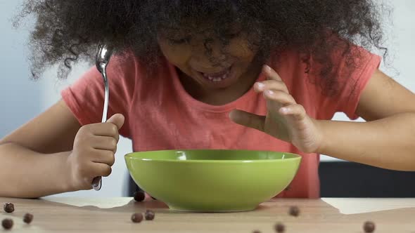 Excited Child Looking at Falling Chocolate Cereal,  Ready to Eat Beloved Food