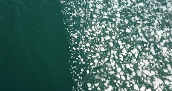 Cinematic downward angle drone shot of sea ice near the Selfoss area in Iceland.