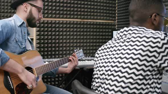 Musician Playing Guitar in Recording Studio