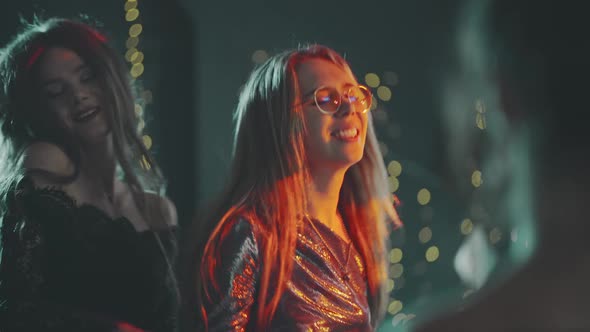 Closeup of Multiracial Young Hipster Friends Dancing at Birthday New Year Christmas or Xmas Party