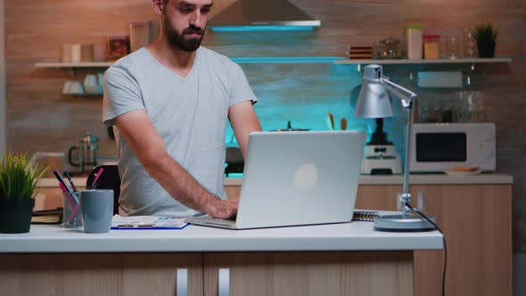 Man Looking at Watch Closing Laptop and Leaving