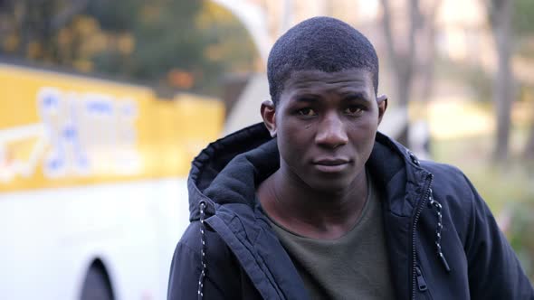 Confident attractive young black african man looking at camera in the street