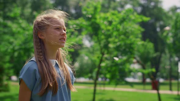 Portrait of Focused Girl Playing Game on Nature