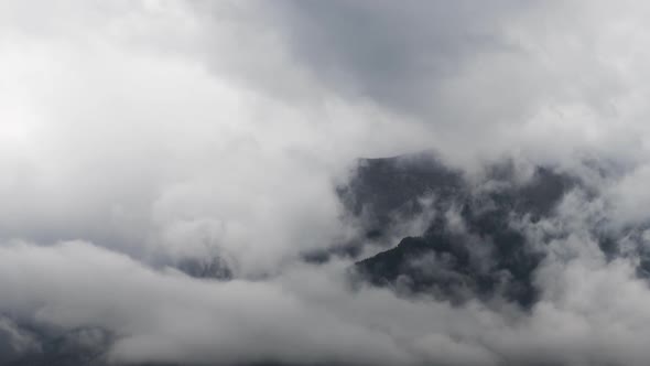 Close Up of Clouds Flowing Around Mountain Peaks Time Lapse 