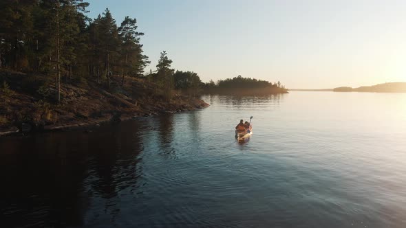 Aerial Drone Flying Over Lake, Woman with Child Swim on Kayak on Background of Sunset, Active Family