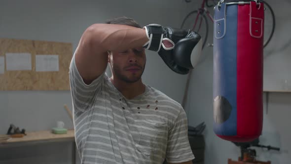 Slow Motion, Athlete in Boxing Gloves Wipes His Face with Hand