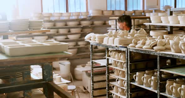 Male potter checking pottery 