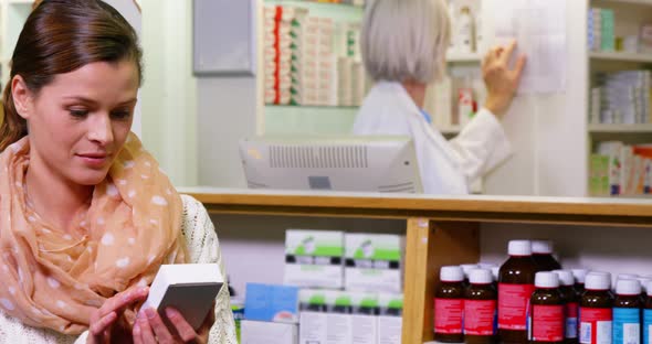 Customer holding a medicine box in pharmacy