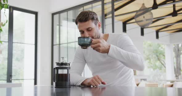 Man drinking coffee at dining table in a comfortable home 4k