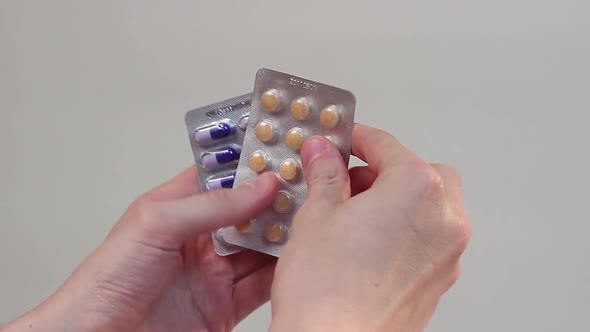 Patient Holds Medicine Blister Packs in Hands, Medical Treatment