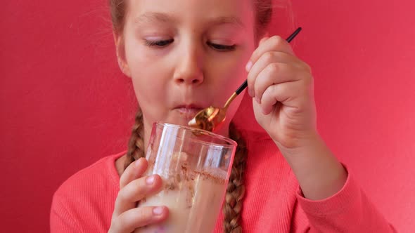 Child eating yogurt jelly pink background Dairy product diet Lactobacillus Acidophilus healthy food