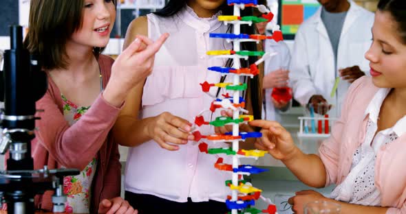 School students experimenting molecule model in laboratory