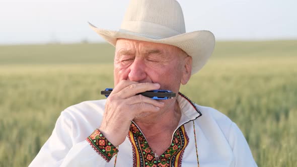 An Old Peasant in Ukrainian Clothes in a Field