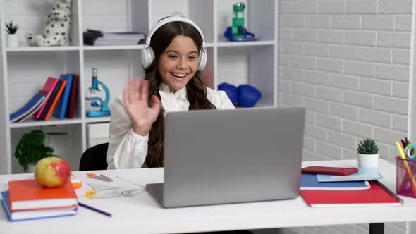 Cheerful Kid in Headphones Finished Online Education on Computer and Used Smartphone School