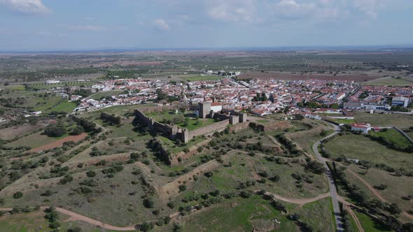 Aerial circling around Mourao castle and surrounding landscape, Portugal